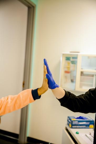 the team at krewe of smiles in metairie la high-fiving