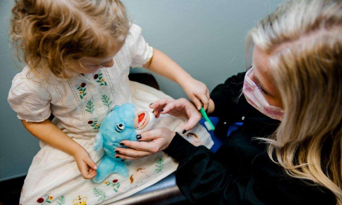 krewe of smiles team member having fun with a patient