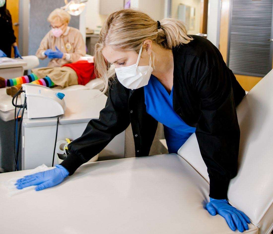 krewe of smiles team member cleaning a dental chair